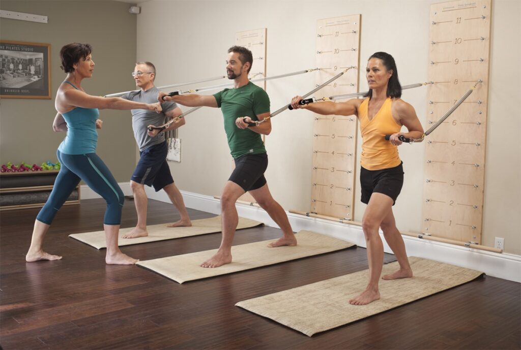 Group using Pilates Springboard for full body exercises.