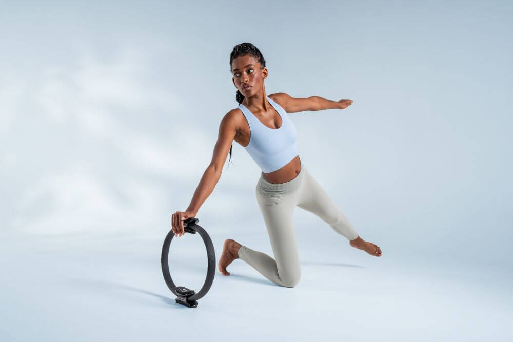 Woman demonstrating Pilates exercise with Ultra-Fit Circle.