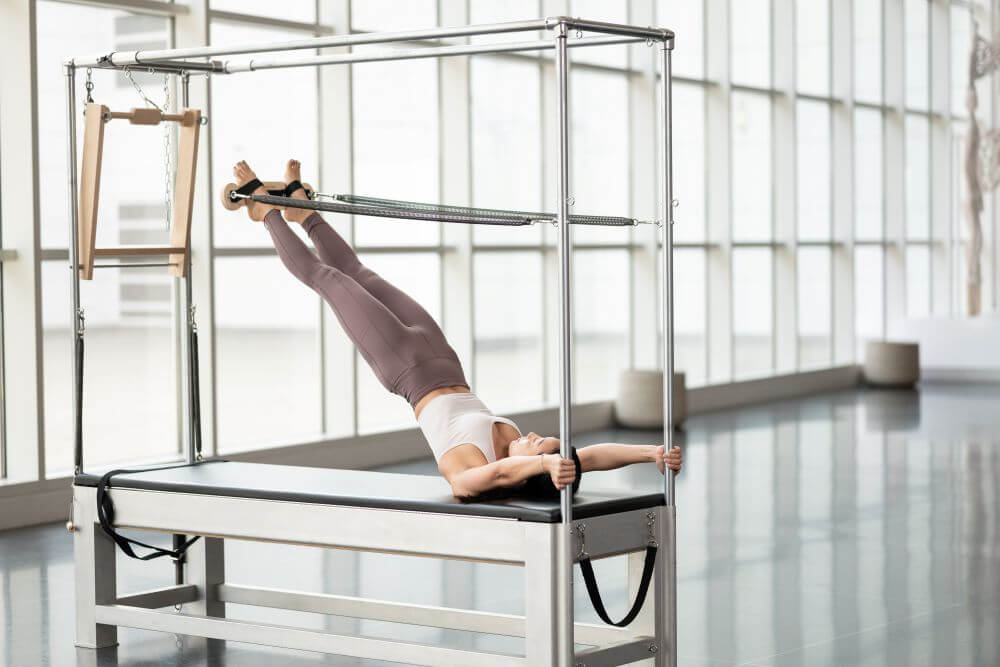 Contrology Airplane Board on Cadillac for advanced Pilates exercise.