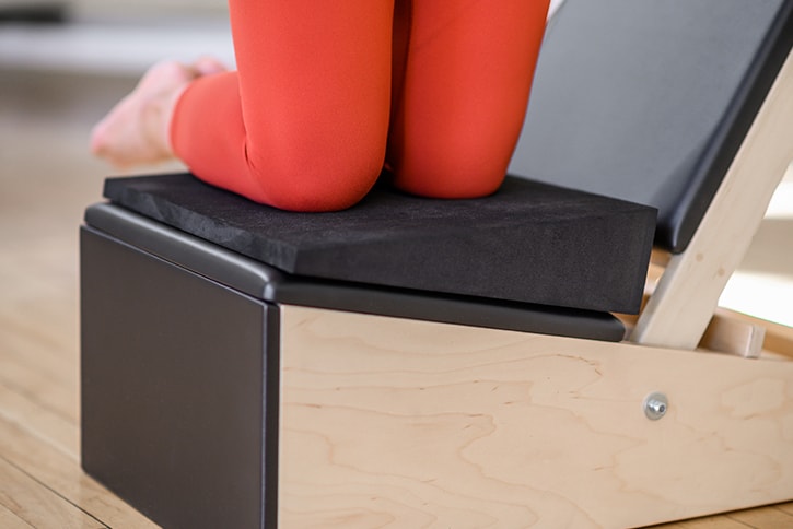 Contrology Arm Chair with adjustable backrest and user exercising