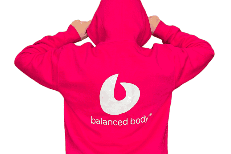 Back view of Balanced Body Hoodie in pink with logo.