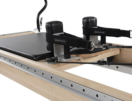 Balanced Body Pilates carriage with 8-wheel system and headrest.