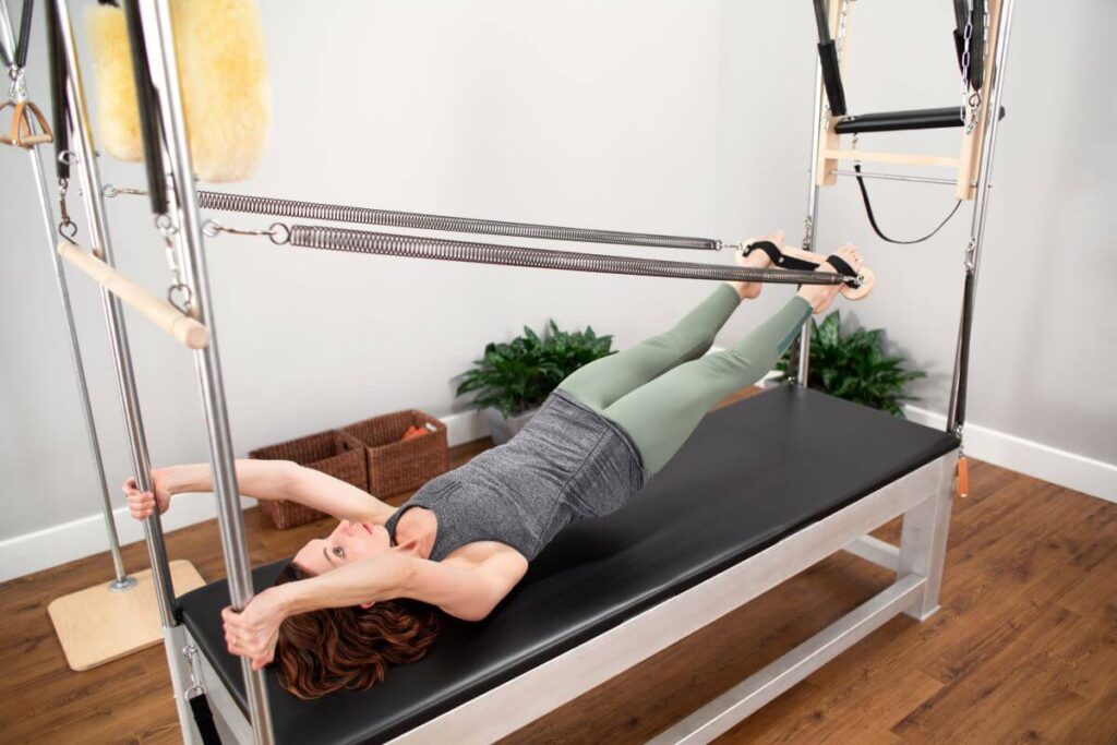 Pilates exercise using Contrology Cadillac JPack Springs.