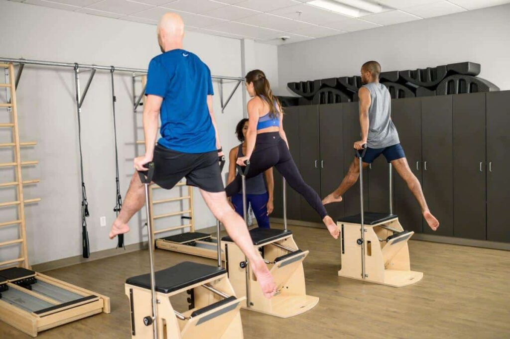 Fitness class using Balanced Body Wunda Chair for Pilates.
