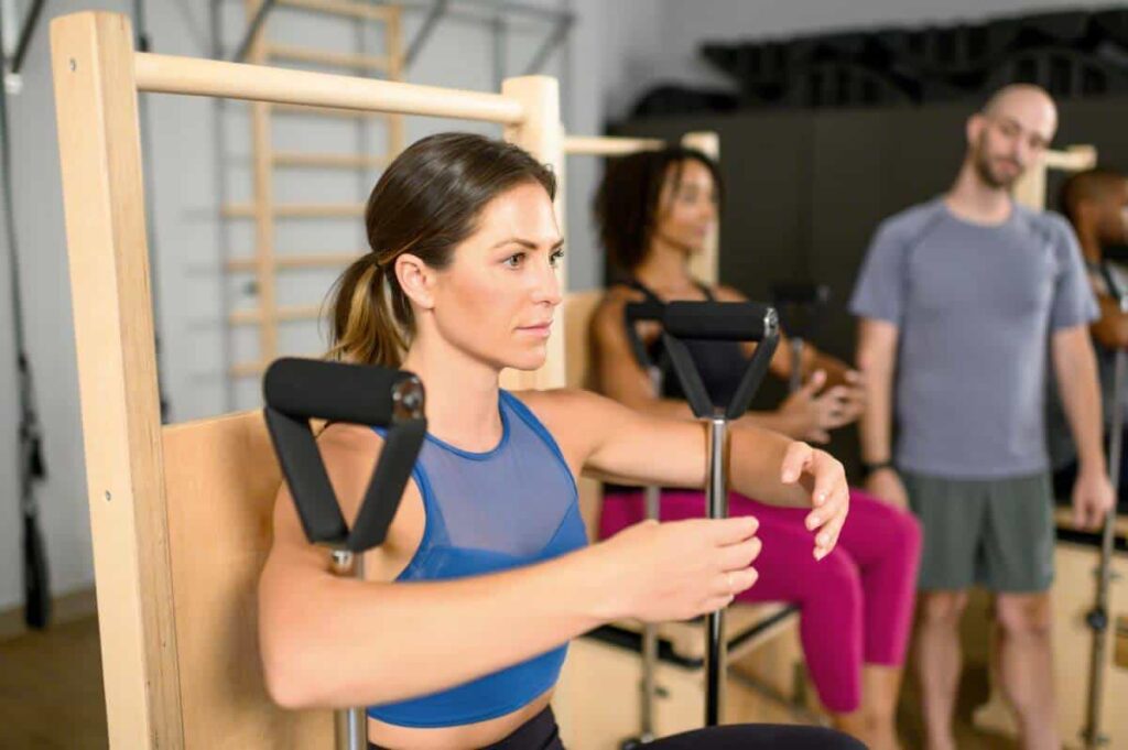 Professional using Balanced Body Wunda Chair in Pilates class.