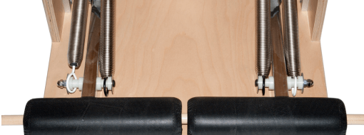 Pilates equipment with color-coded hooks showing resistance levels