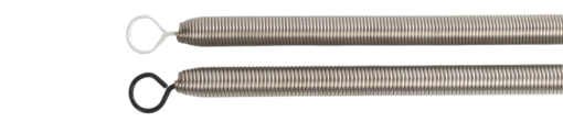 Pilates equipment springs with white and black resistance ends.