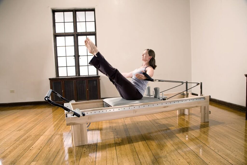 Woman exercising on Clinical Reformer for rehabilitation