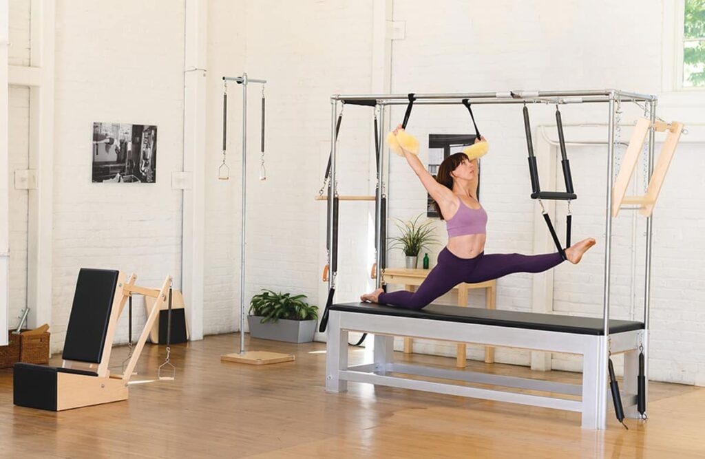 Contrology Cadillac in use for advanced Pilates stretching.