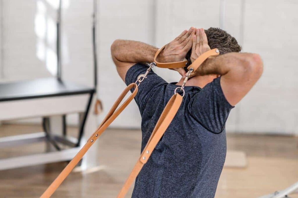 Man using Contrology Leather Handles for Pilates exercise