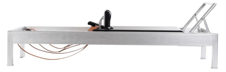 Professional Pilates equipment with satin aluminum frame and leather straps.