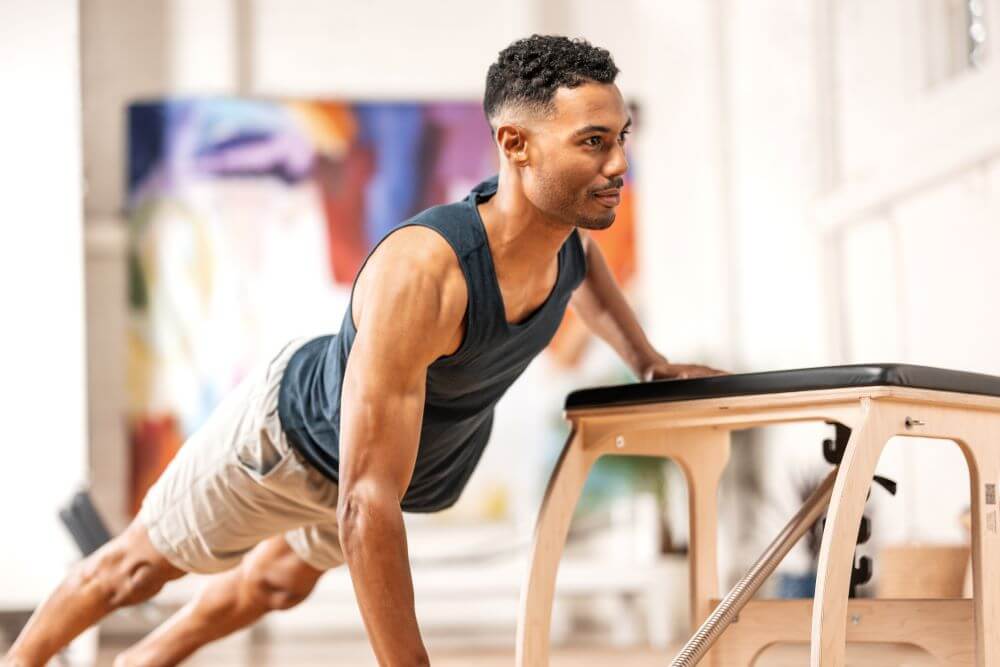 Man exercising on Pilates EXO Chair for full body workout