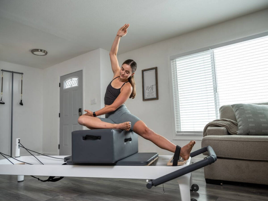 Pilates Footstrap with Sitting Box on Reformer in use.