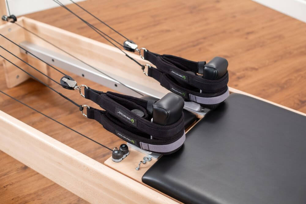 Studio Reformer Konnector with adjustable straps and pulleys.