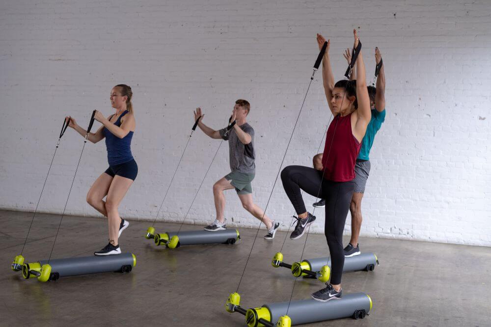 Group using MOTR for cardio and balance exercises in studio.