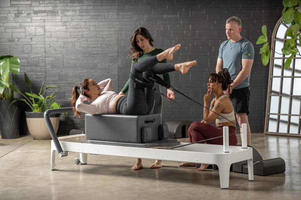 Pilates class using Allegro 2 Reformer in a studio setting.