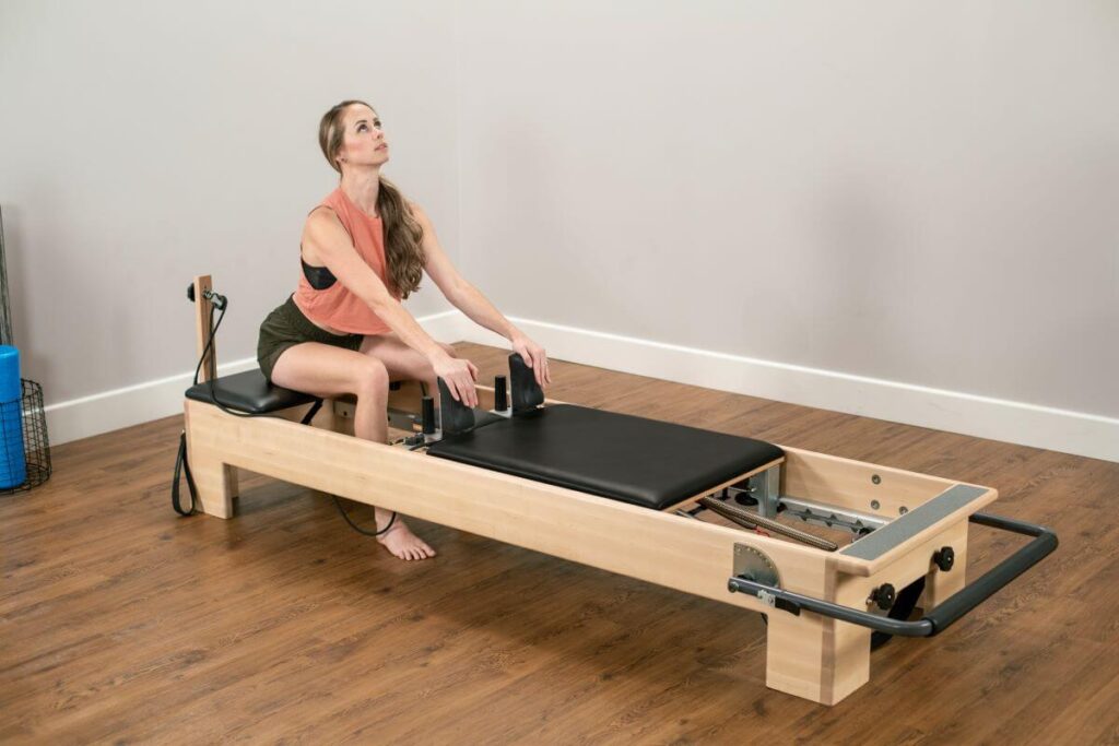 Woman demonstrating exercises on the Studio Add-a-Platform.