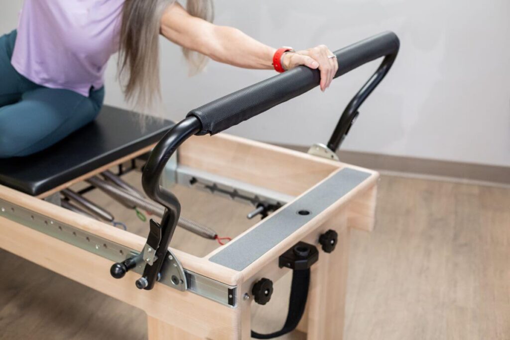 Pilates Reformer with Signature Springs in use at studio.