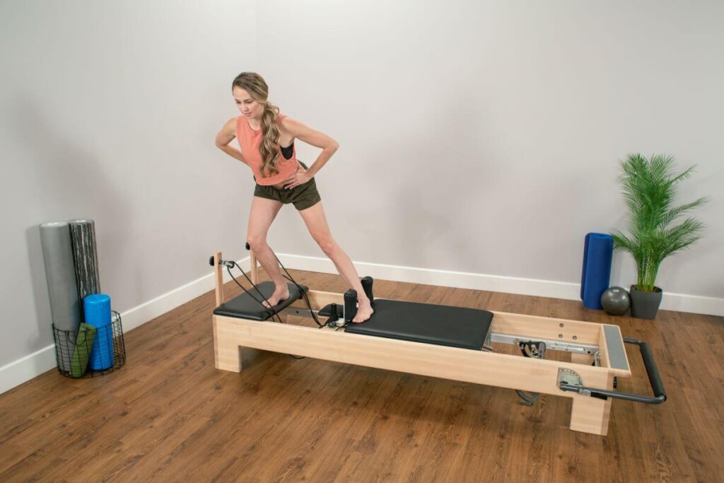 Person using Balanced Body Studio Add-a-Platform on a Reformer.