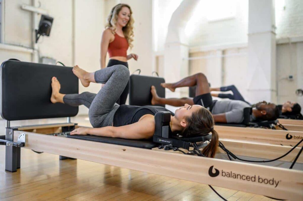 Pilates class using Balanced Body Rialto Reformer Jumpboard.