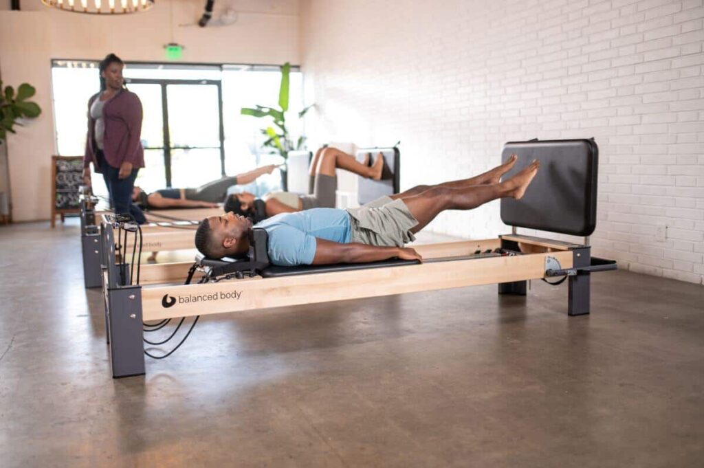 Pilates students using Rialto Reformer Jumpboard in a studio.