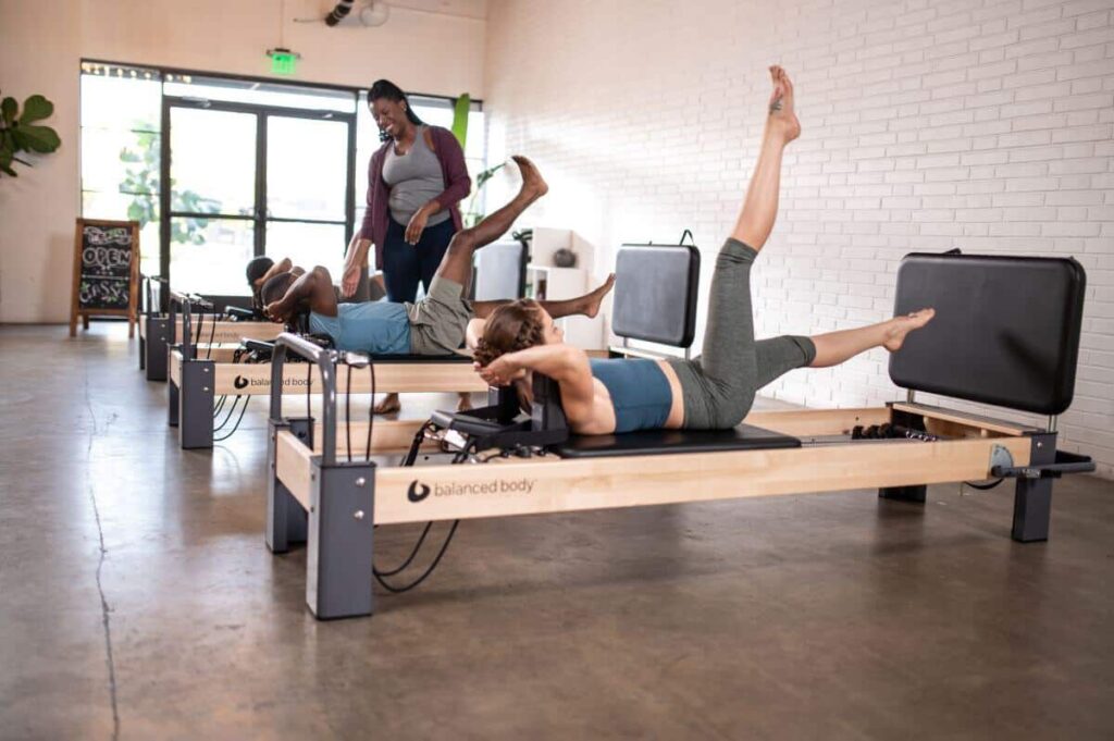 Pilates class using Balanced Body Rialto Reformer Jumpboard.