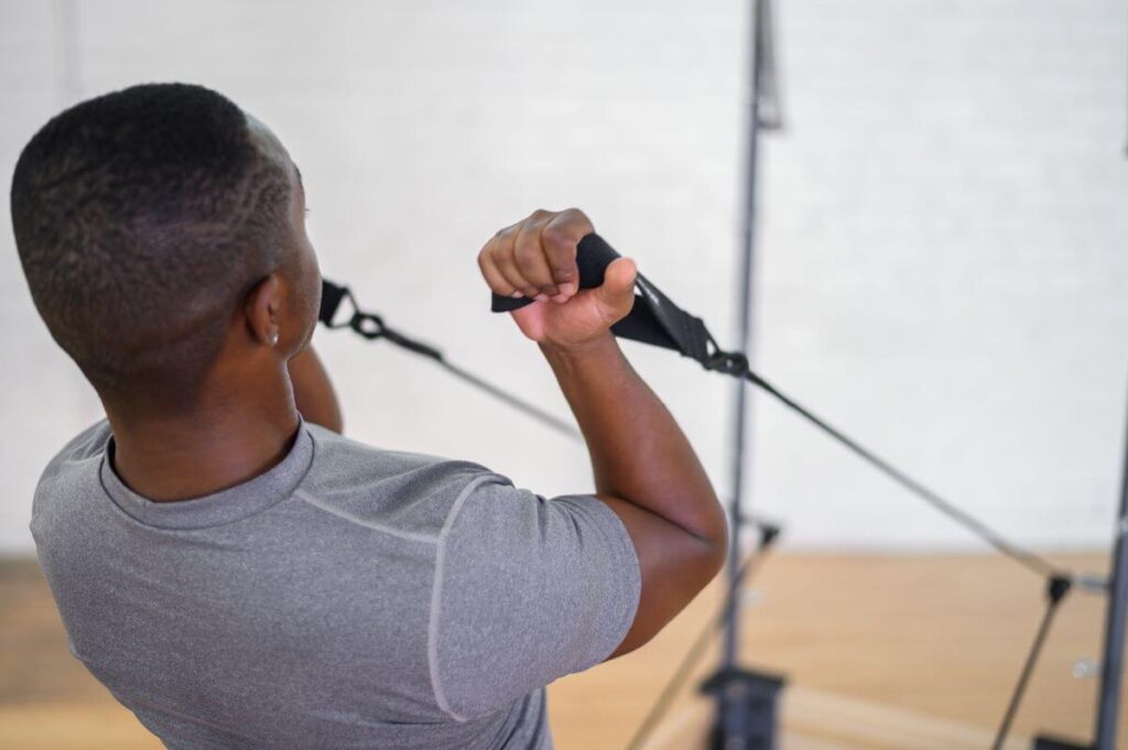 Man using Single Loops from Balanced Body in a workout.