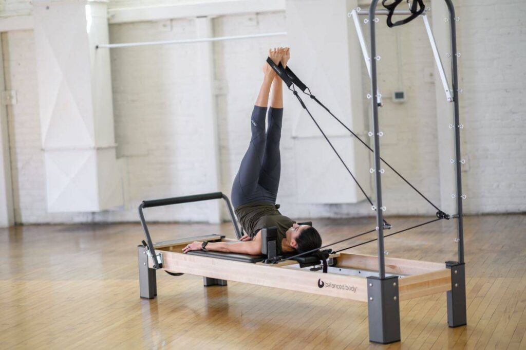 Pilates exercise using Balanced Body Single Loops on a Reformer.