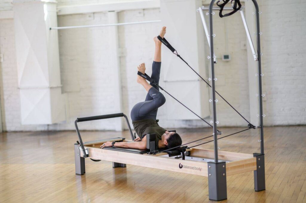 Person using Balanced Body Single Loops on a Pilates Reformer.