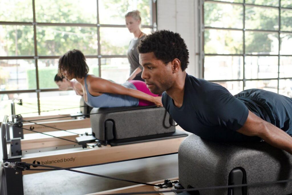 Pilates class using Sitting Box Lite on reformers at studio