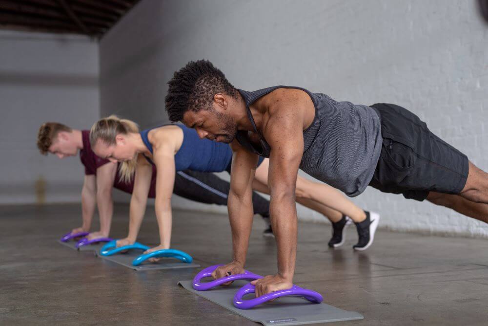 Group exercise using Balanced Body SmartBell for core training.