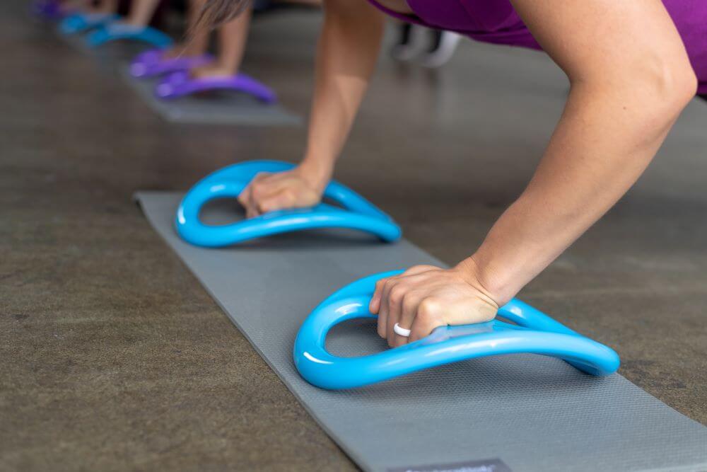Person using Balanced Body SmartBell for push-up exercises.