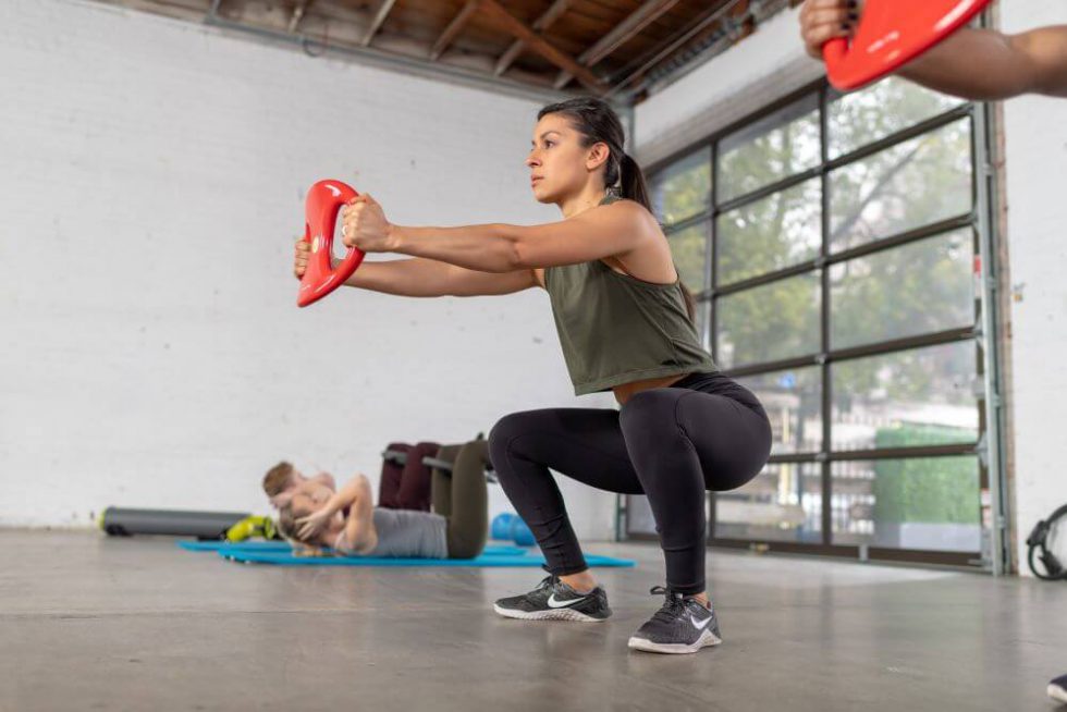 Person exercising with SmartBell in a fitness studio.