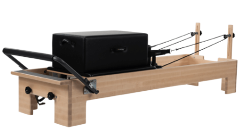 Durable wooden Pilates frame with handles and black upholstery.
