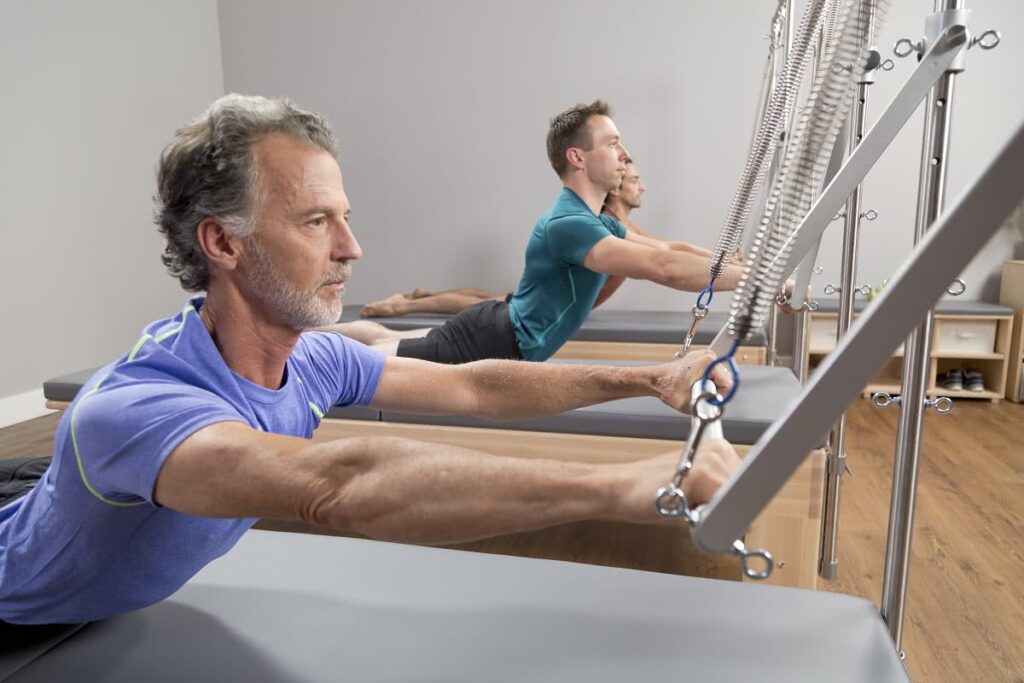 Pilates instructors using Studio Reformer with Tower equipment