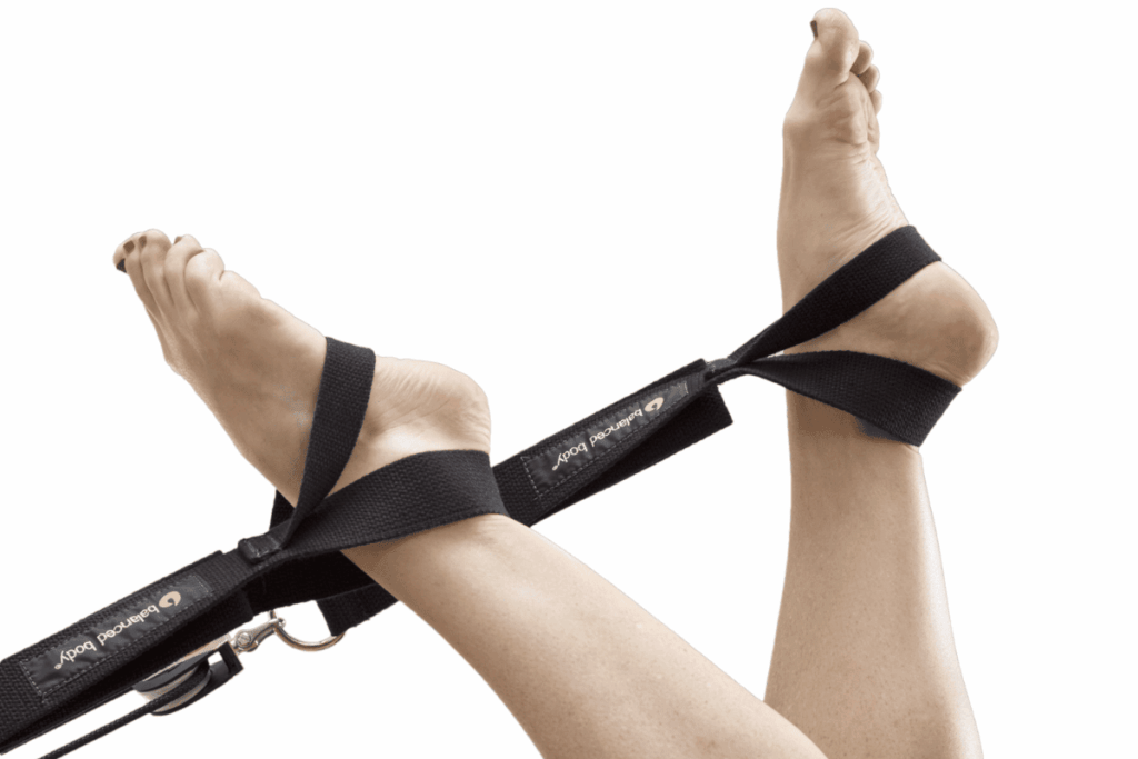 Feet using Balanced Body Tri Loops for Pilates support.