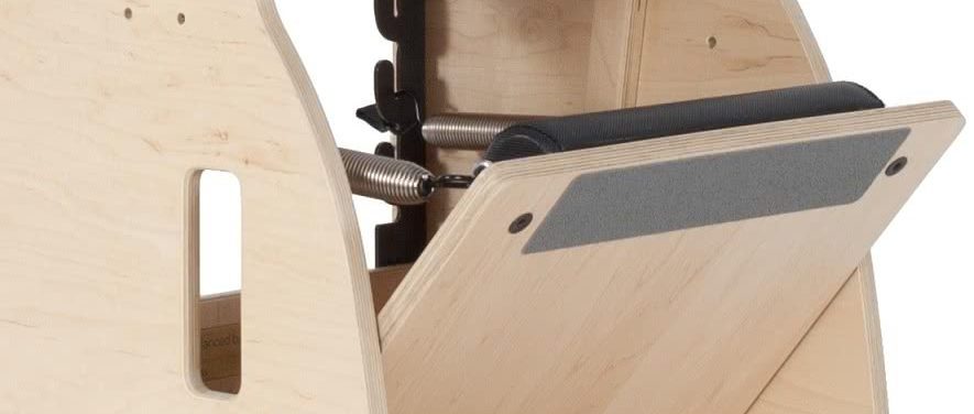 Pilates chair footstep with black non-slip padding for safety.