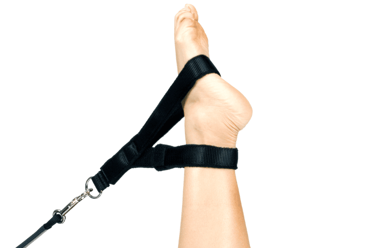 Y-Loops attached to foot on a Pilates reformer.