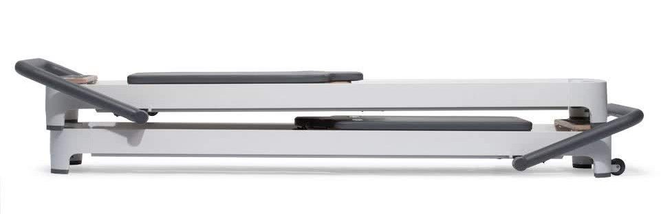 Pilates Reformer Storage and Transport Feature Pilates reformer showing vertical and stacked storage configuration.