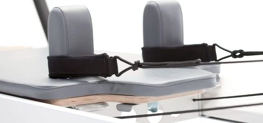 Carriage Feature: Integrated Headrest & Storm Upholstery Pilates reformer carriage with integrated headrest and storm color upholstery.