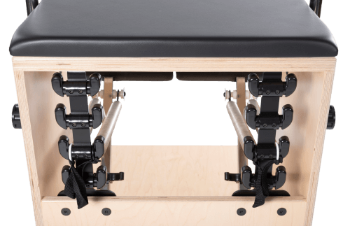 Stable Pilates frame with wheels, black padded seat, maple laminate.
