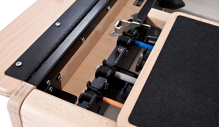 Close-up of Pilates equipment feature with adjustable mechanisms.