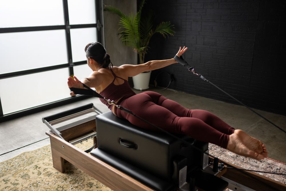 Pilates exercise with New York Sitting Box on Reformer.