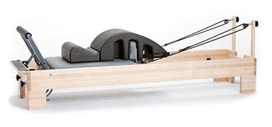 Wedge for reformer offering back support and stability in Pilates.