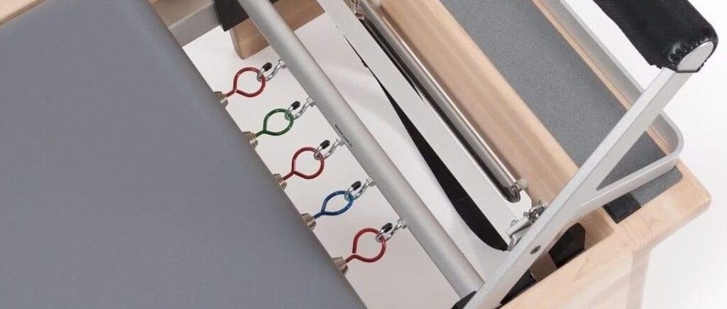 Balanced Body Pilates equipment with Signature Springs in blue, red, and green.