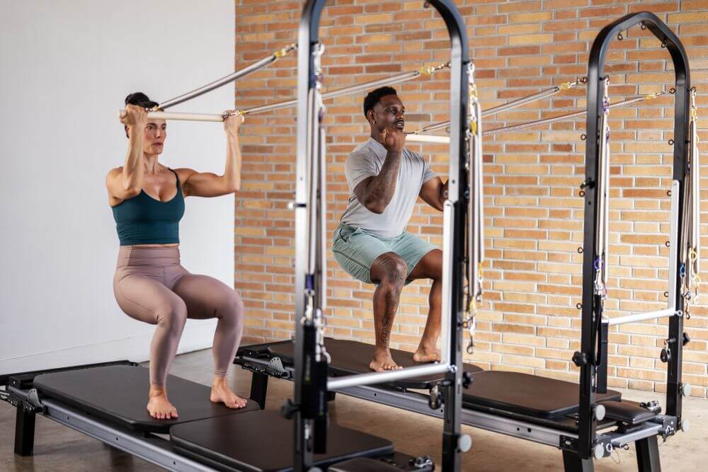 Pilates exercise on Allegro Nextgen Reformer with Tower in studio.