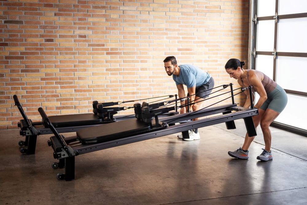 Trainers assembling Allegro Nextgen Reformer in studio.