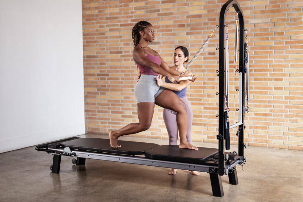 Instructors using the Allegro Nextgen Reformer with Tower in studio.