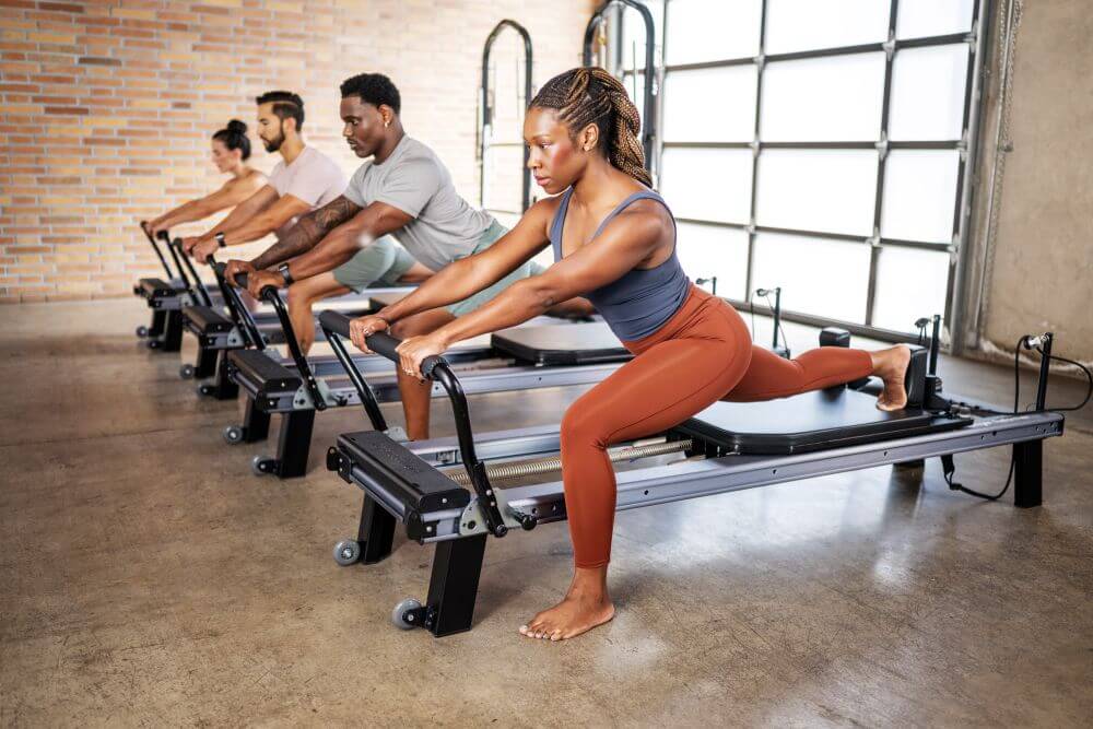 Group using Allegro Nextgen Reformers in a Pilates studio.
