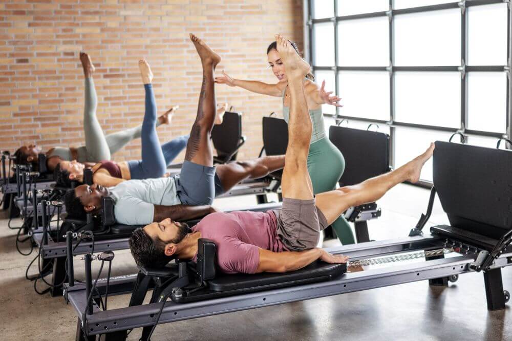 Instructors using Allegro Nextgen Reformers in a Pilates studio.